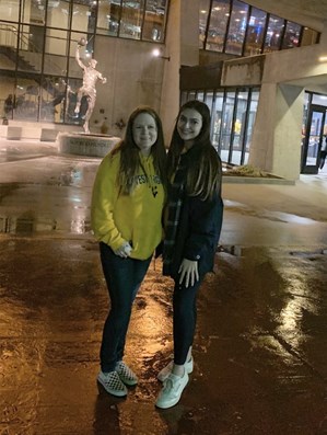 Amara Garity and her mother Jamie pose in front of the Jerry West statue in front of the Coliseum.