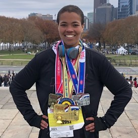 Sarah standing with 3 medals in Philadelphia